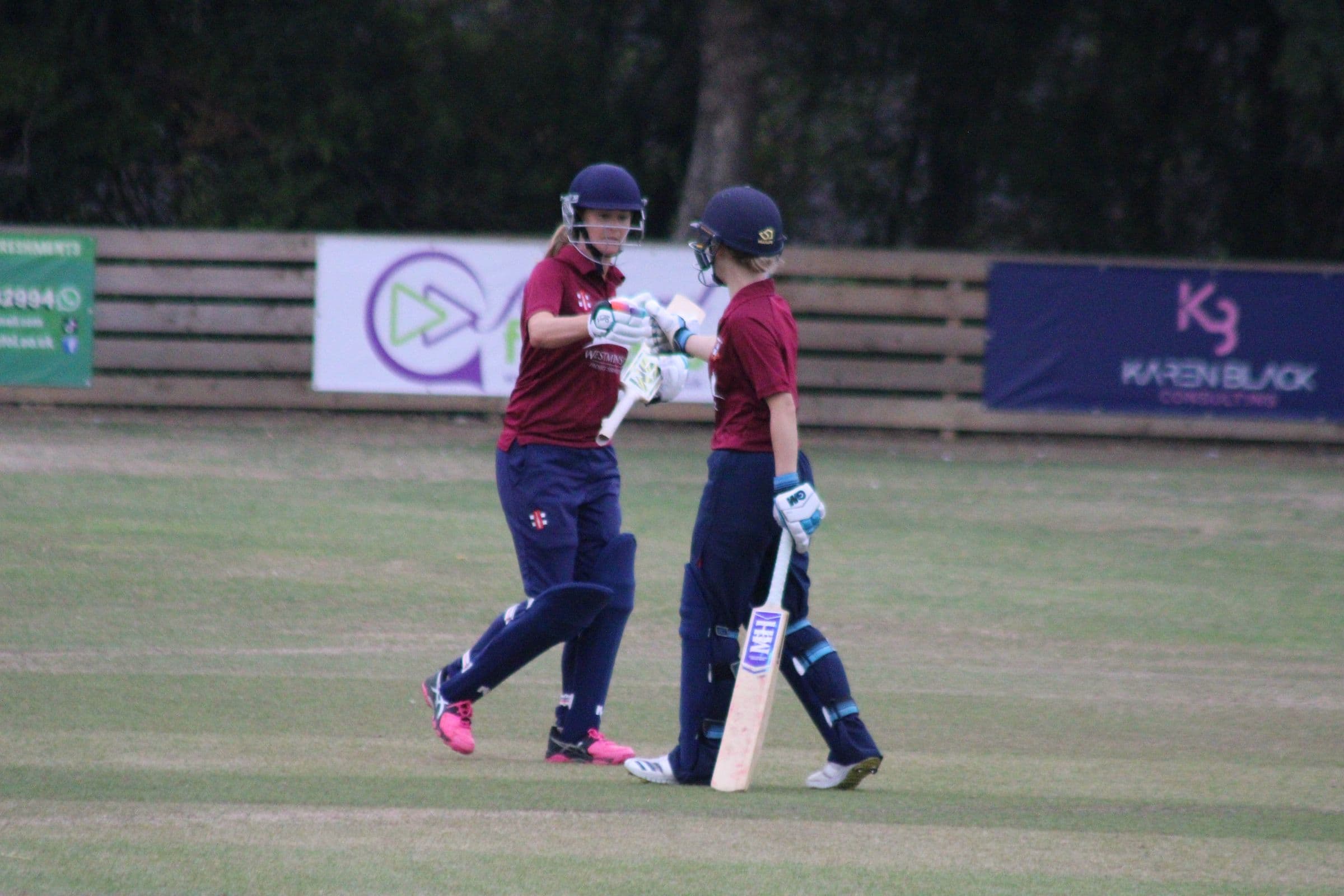 Two Tewkesbury batters touching gloves mid-innings