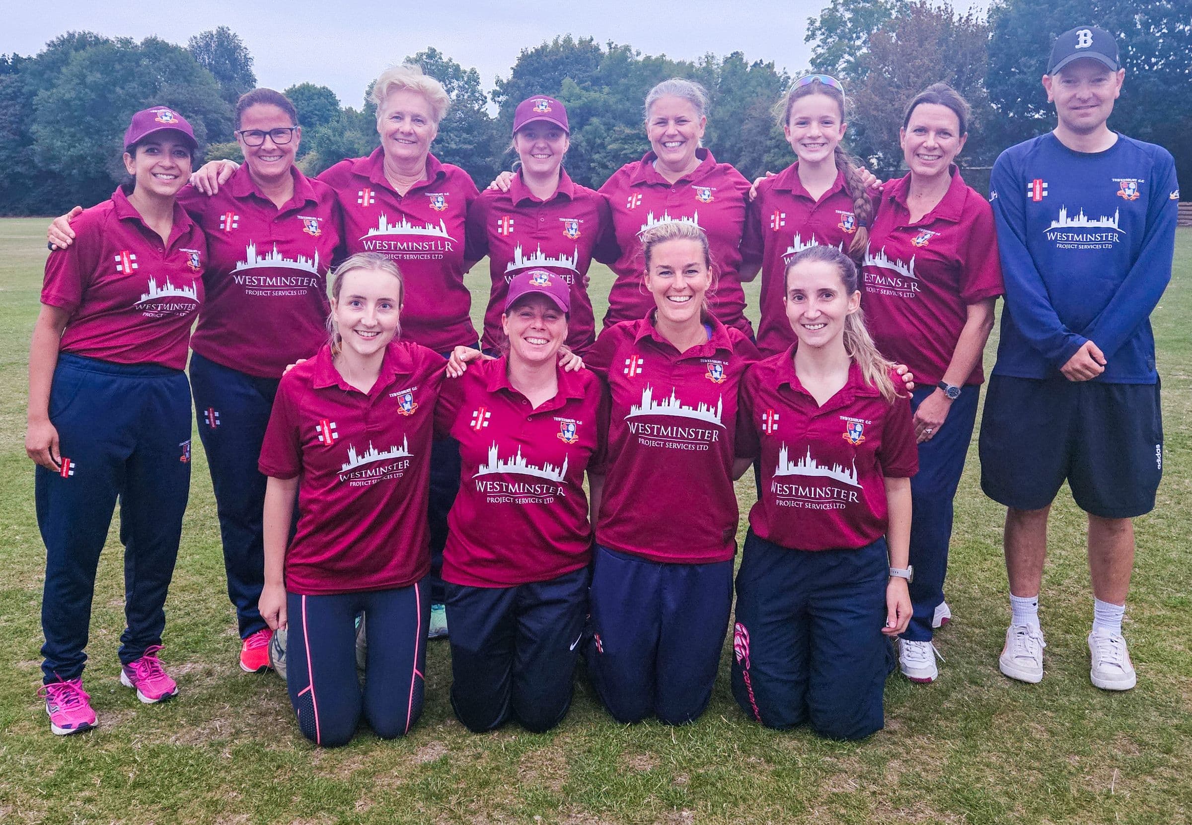 The Tewkesbury women's team in maroon shirts with their coach