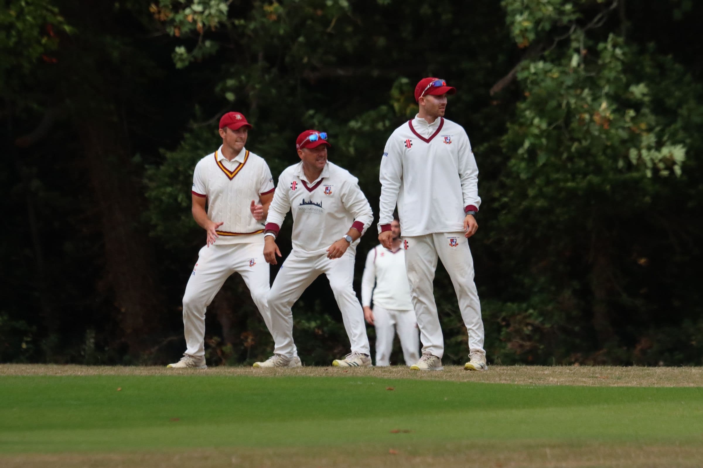 Three Tewkesbury slip fielders crouched and ready