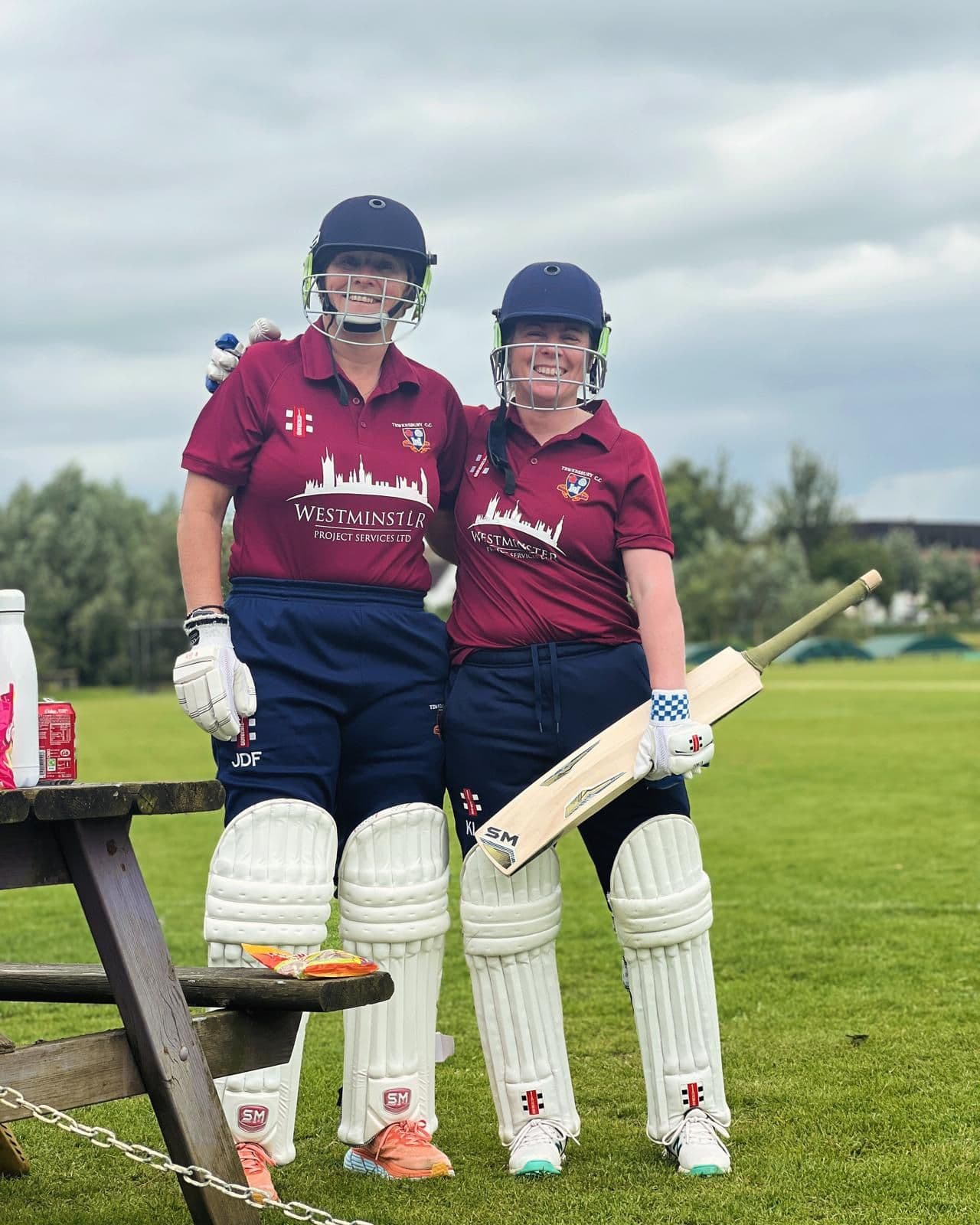 Two Tewkesbury batters, padded up and helmeted, waiting to go in